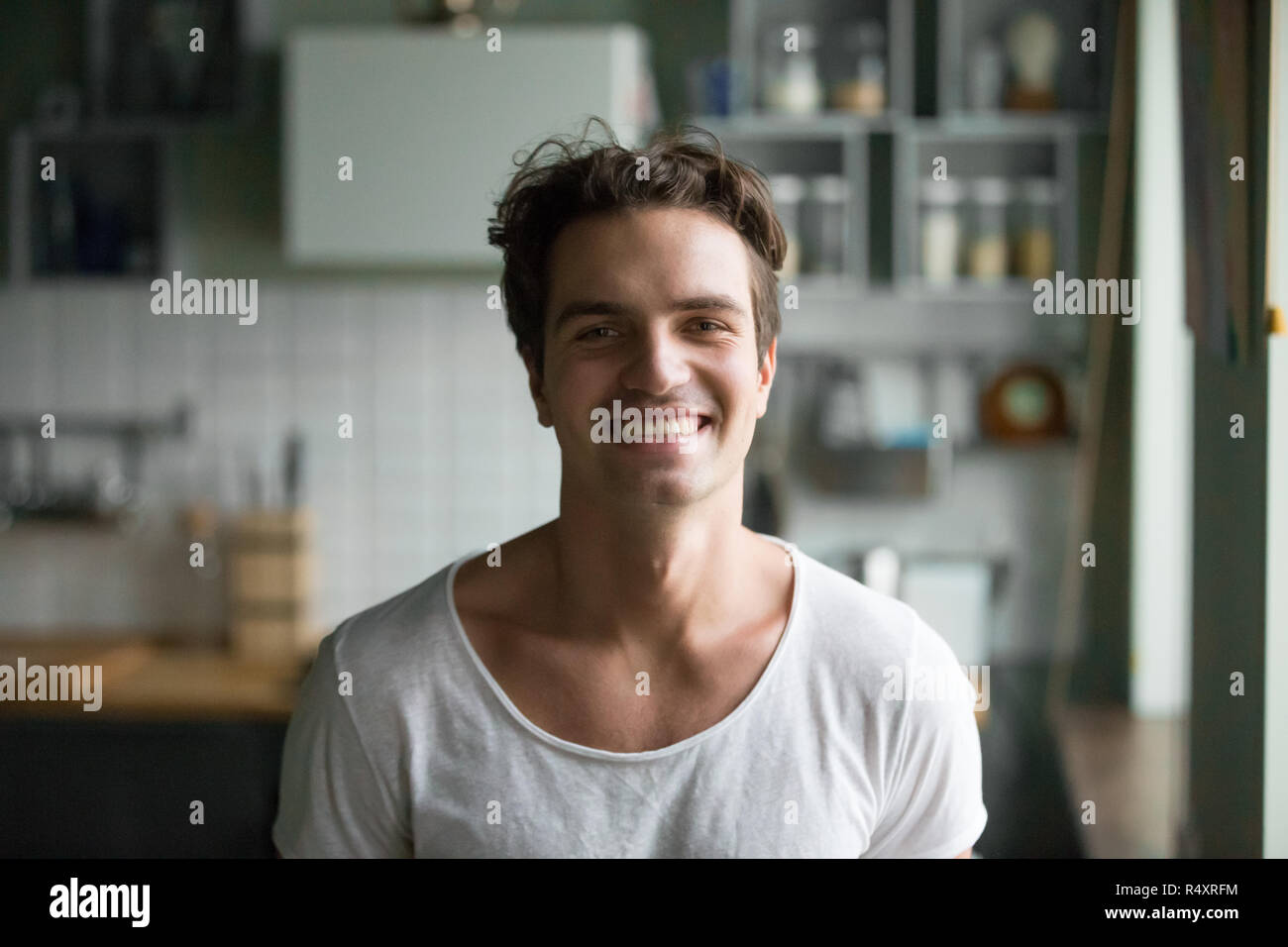 Handsome young man at home looking at camera Stock Photo