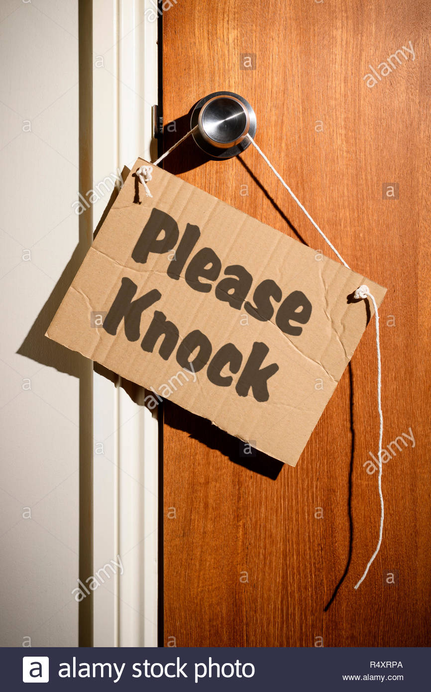 Please Knock Written On A Makeshift Sign Hanging On The Door