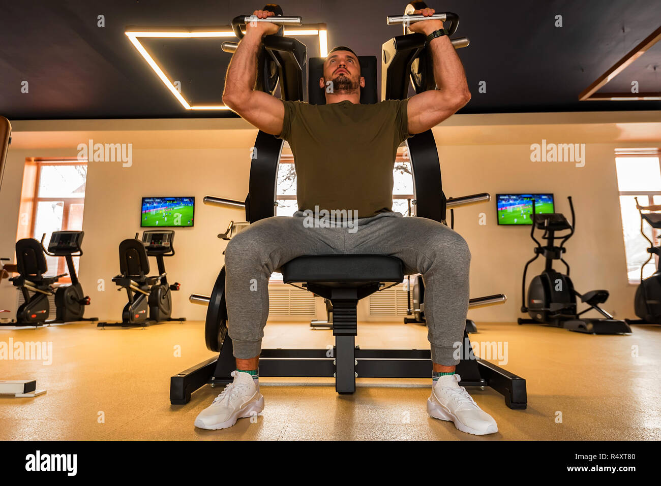 Young Muscular Man Does Lower Chest Exercises With Machine Young Muscular Man Does Lower Chest Exercises With Machine