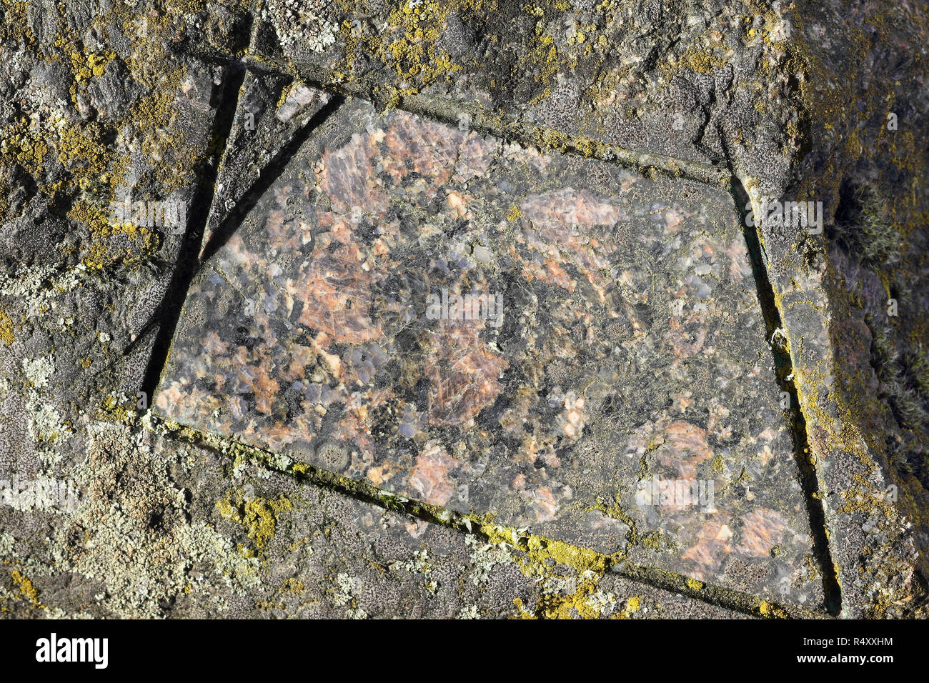 Natural and polished surface of a boulder of Filipstad Granite, close-up Stock Photo