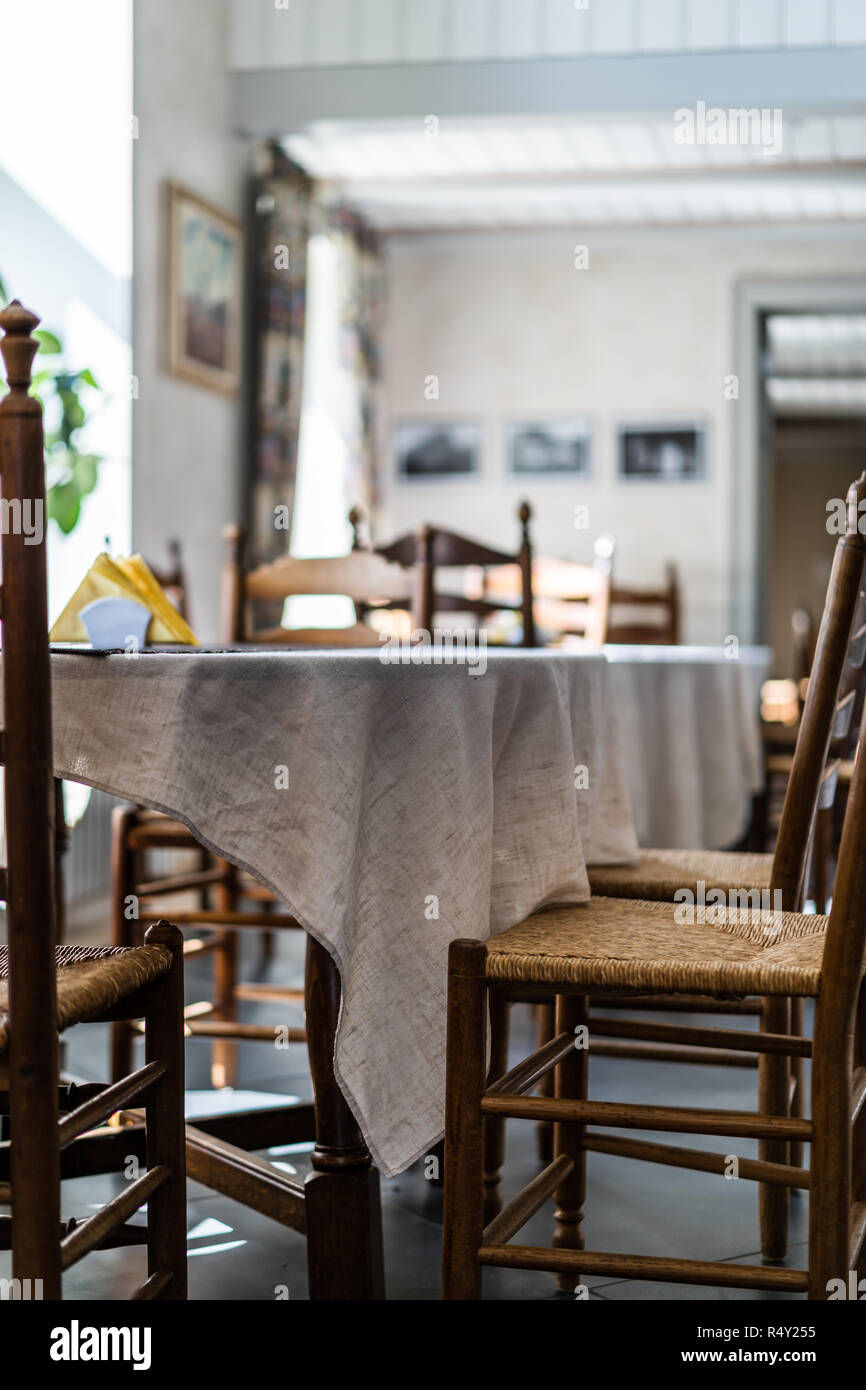 Empty Restaurant Table in Hotel with Yellow Napkins on it - Window Seat with Bright Light Stock Photo