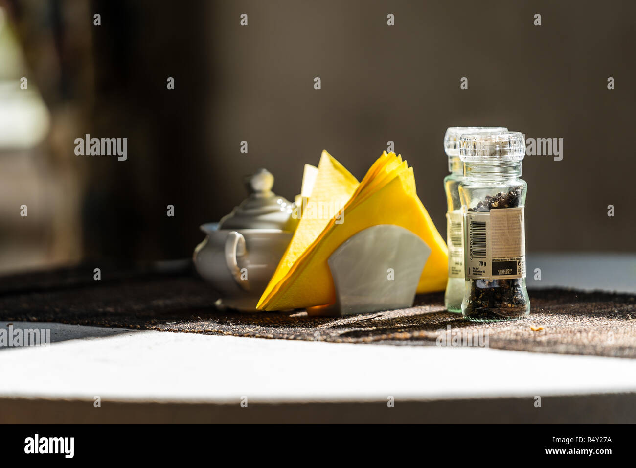 Empty Restaurant Table in Hotel with Yellow Napkins on it - Window Seat with Bright Light Stock Photo