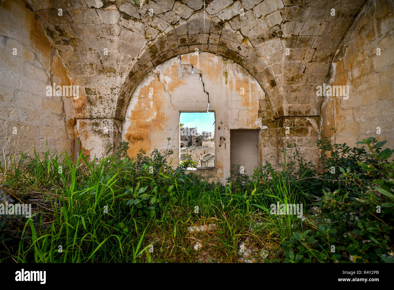 A window in an ancient wall in the prehistoric city of Matera in the Basilicata region of Southern Italy. Stock Photo