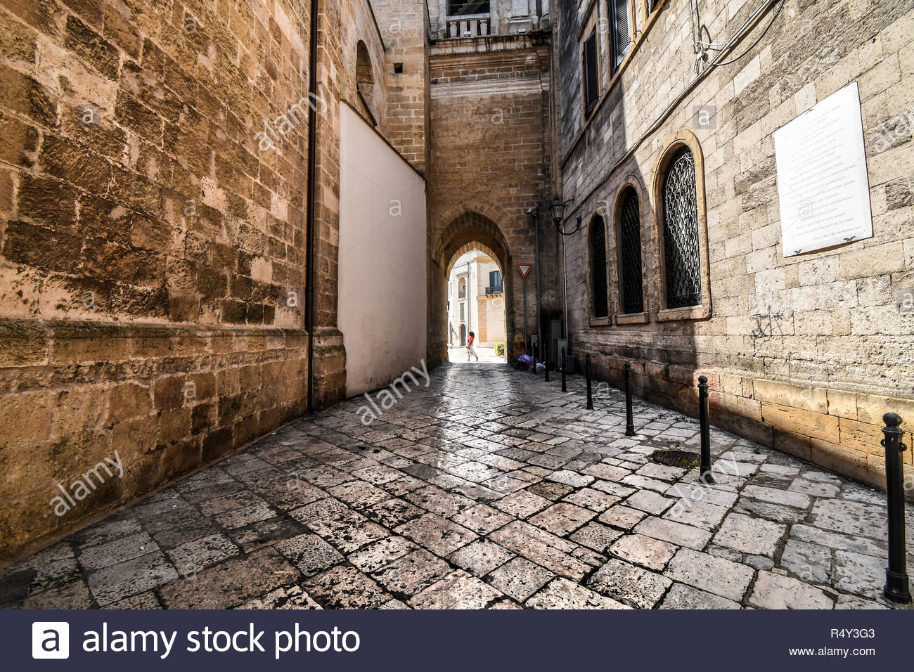 A Woman Passes By A Medieval Arch Near The Brindisi Duomo In The