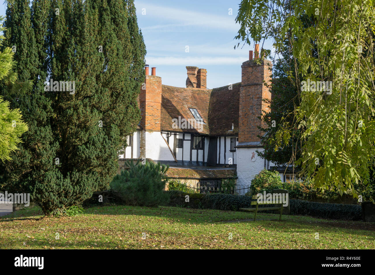 The Twisted Chimney House viewed from the Old Churchyard, Buckingham, UK; an Elizabethan house noted for its distinctive twisted red brick chimney. Stock Photo