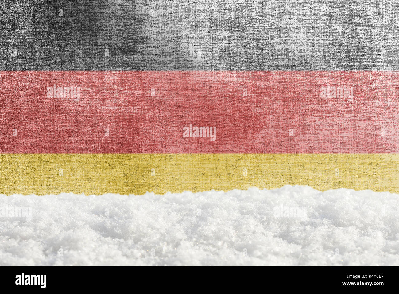 Winter grunge background with snowdrift and German flag in the backdrop ...