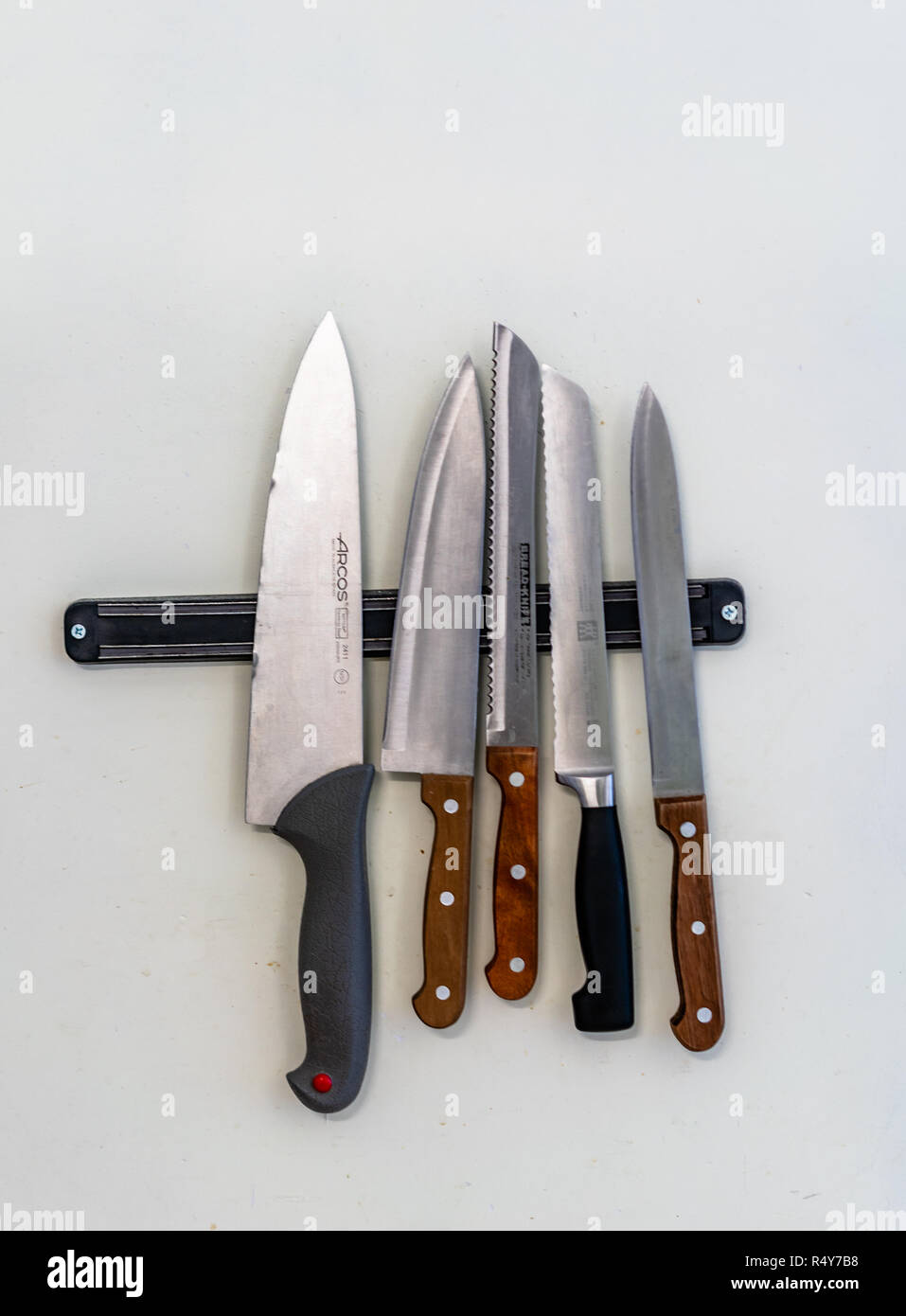 Some Kitchen Knives Hanging on the Kitchen Wall - Tool Set Stock Photo