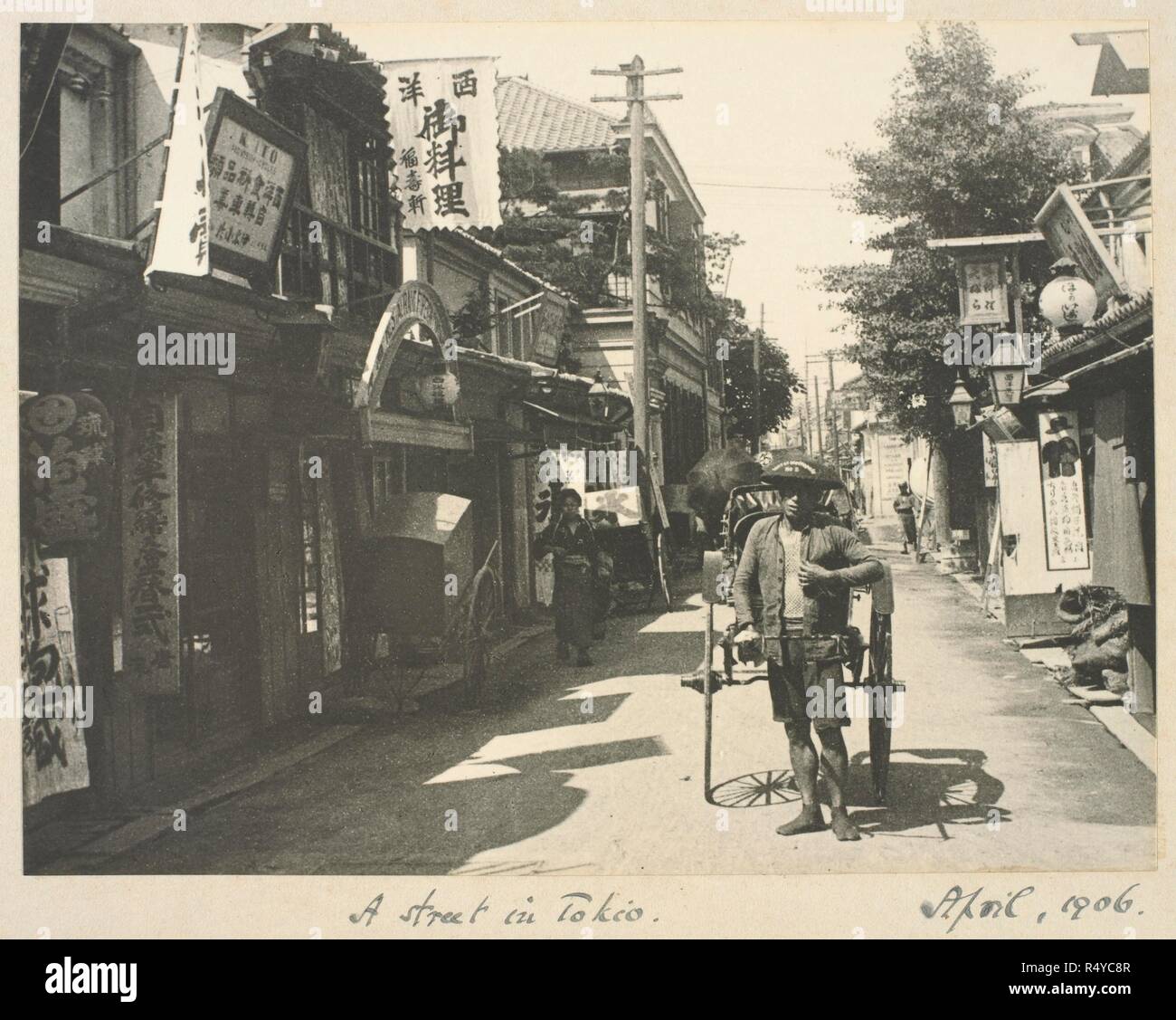 A photograph of a nineteenth-century Tokyo street. A young man pulling a rickshaw. Zetland Collection: Album of views of ... Japan and ... Apr-06. Source: Photo 364/7(8). Language: English. Author: Zetland, 2nd Marquess of. Abbott, William. Stock Photo