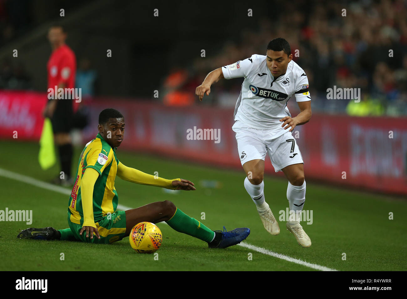 Swansea, Wales, UK. 28th November, 2018. Jefferson Montero of Swansea city goes past Tosin Adarabioyo of West Bromwich Albion. EFL Skybet championship match, Swansea city v West Bromwich Albion at the Liberty Stadium in Swansea, South Wales on Wednesday 28th November 2018.  this image may only be used for Editorial purposes. Editorial use only, license required for commercial use. No use in betting, games or a single club/league/player publications. pic by Andrew Orchard/Andrew Orchard sports photography/Alamy Live news Stock Photo