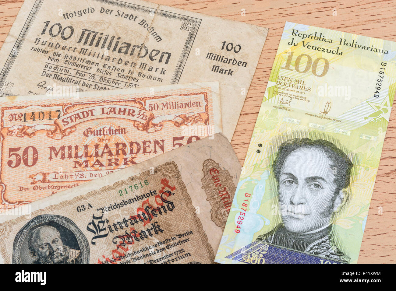Hyperinflation - 2 classic cases: Germany 1920s (1 Billion to 100 Billion Mark notes), with Venezuelan 100,000 Bolivar banknote. Stock Photo