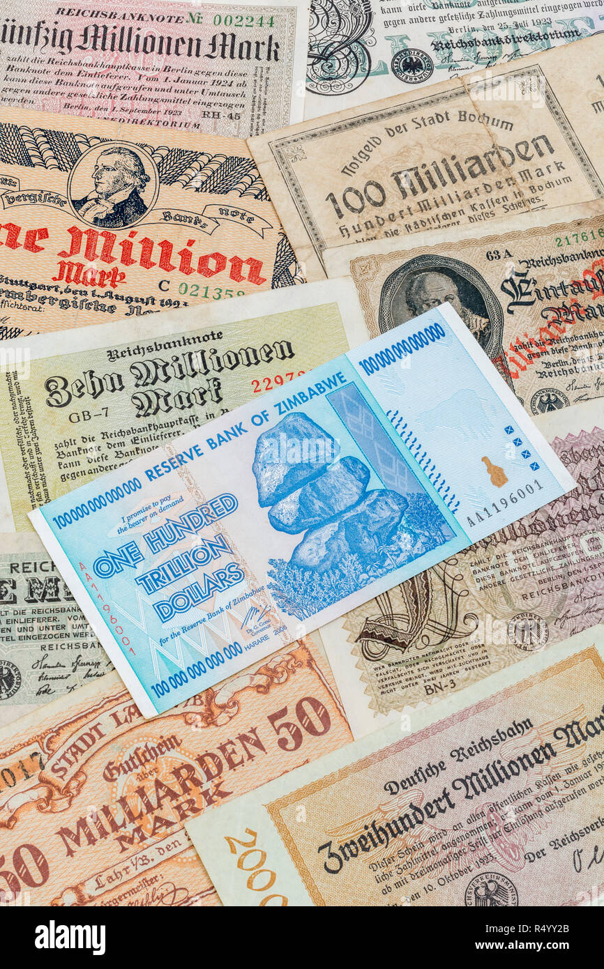 Hyperinflation - 2 classic cases: Germany 1920s (1M to 100Bn marks) Zimbabwe 100 Trillion Dollar (largest denomination banknote ever printed, in 2008) Stock Photo
