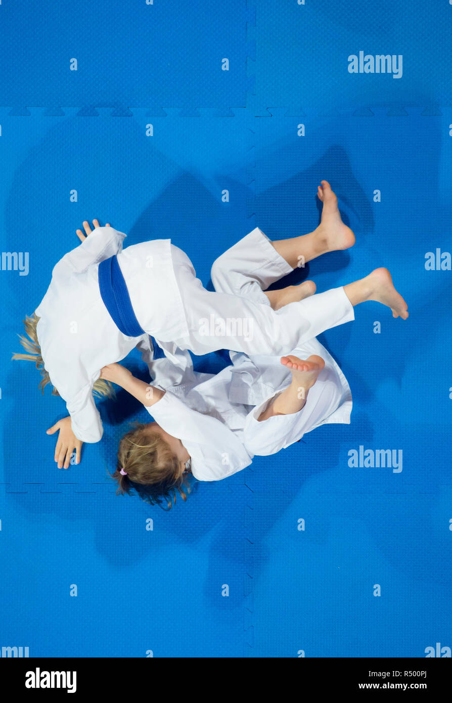 karate do kids fight against blue tatami background. Top View. Sport  competition Stock Photo - Alamy