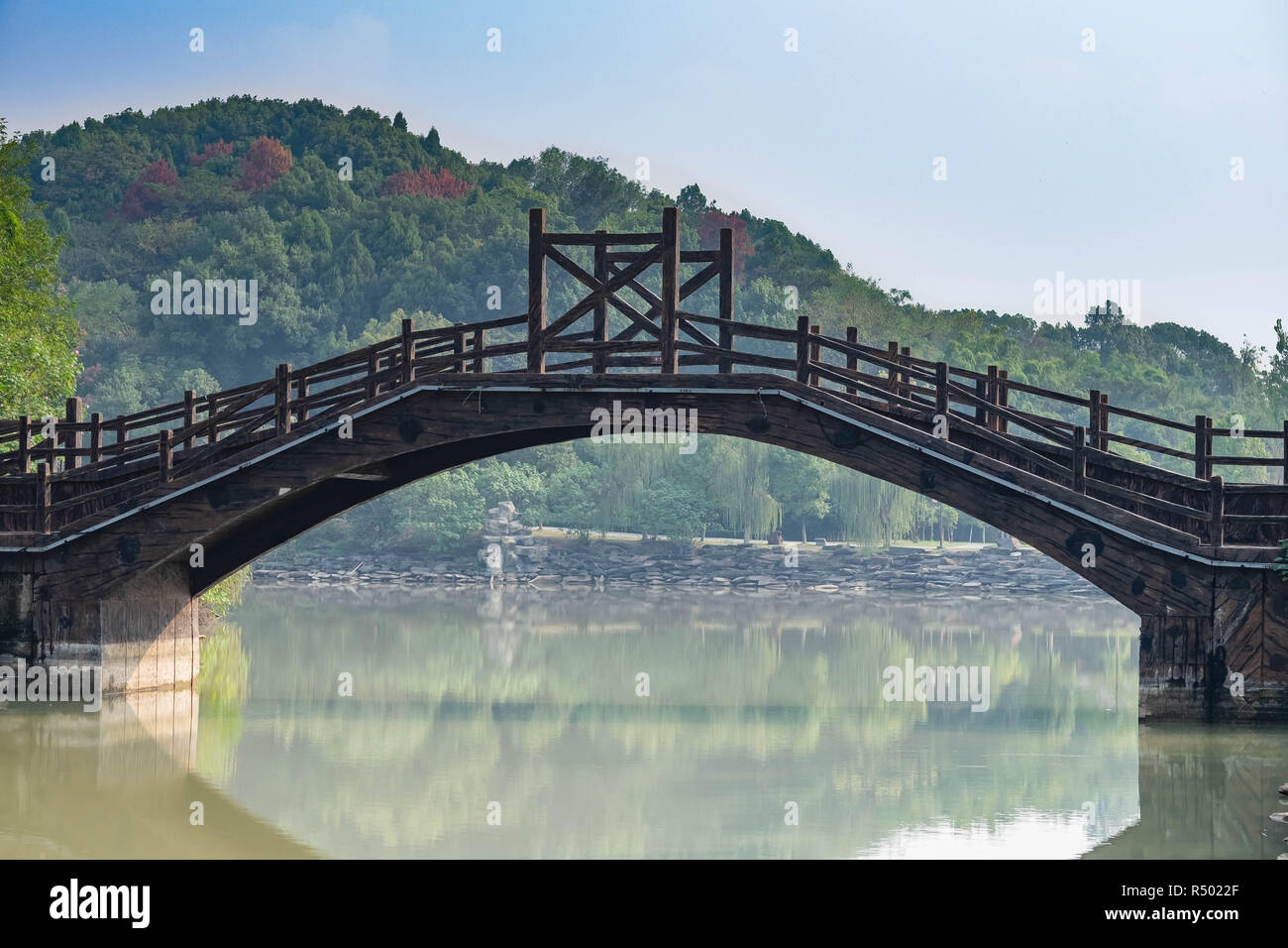 Chinese bridge on a calm canal. At Chibi city. the bridge made from the wooden. Ancient Bridge in three kingdom battle field in Hubei China. Stock Photo