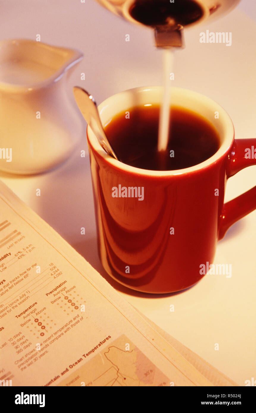 Customer adding sugar to his mug of coffee at a diner, USA Stock Photo