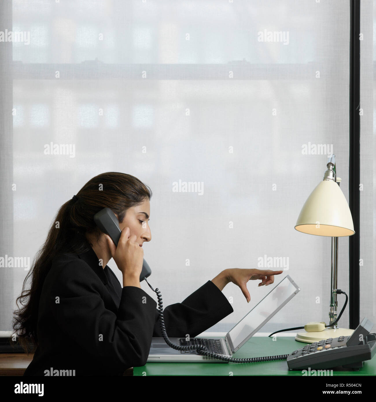 Woman desk phone sideview hi-res stock photography and images - Alamy