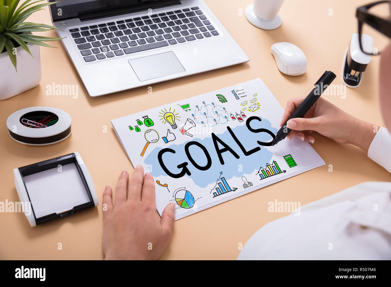 Businessperson Drawing Goals Chart On Office Desk Stock Photo