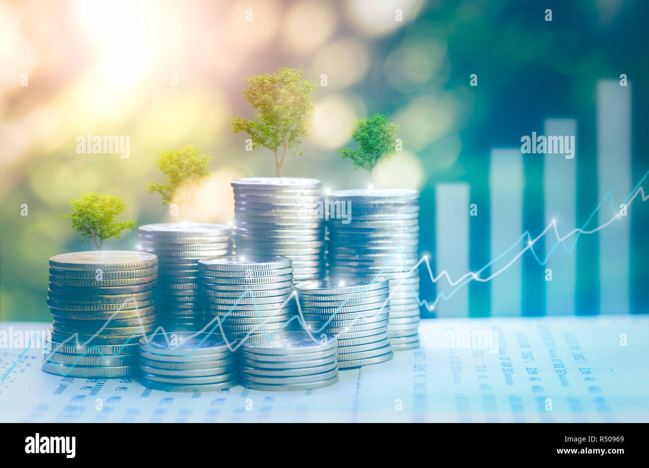 Money growing concept,Business success concept Stable like a big tree Tree growing on pile of coins money,for saving or investment for a house, retire Stock Photo