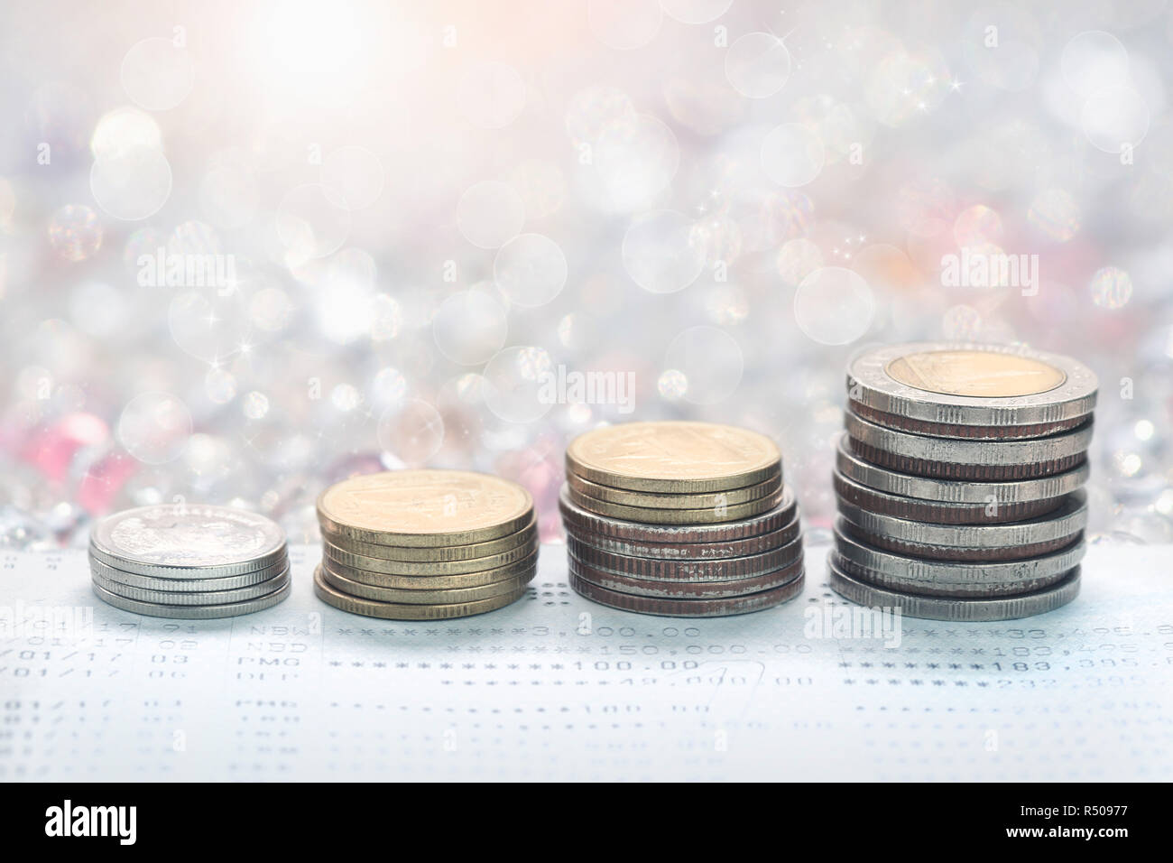 Coins stack in front of bank account book Savings money of coins concept for property ladder,mortgage and real estate investment business Finance and  Stock Photo