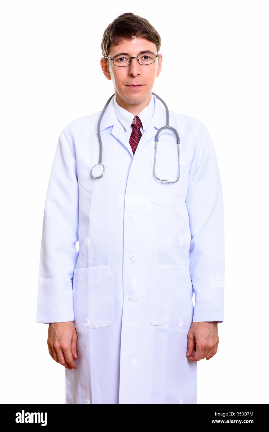 Studio shot of man doctor standing and looking at camera Stock Photo