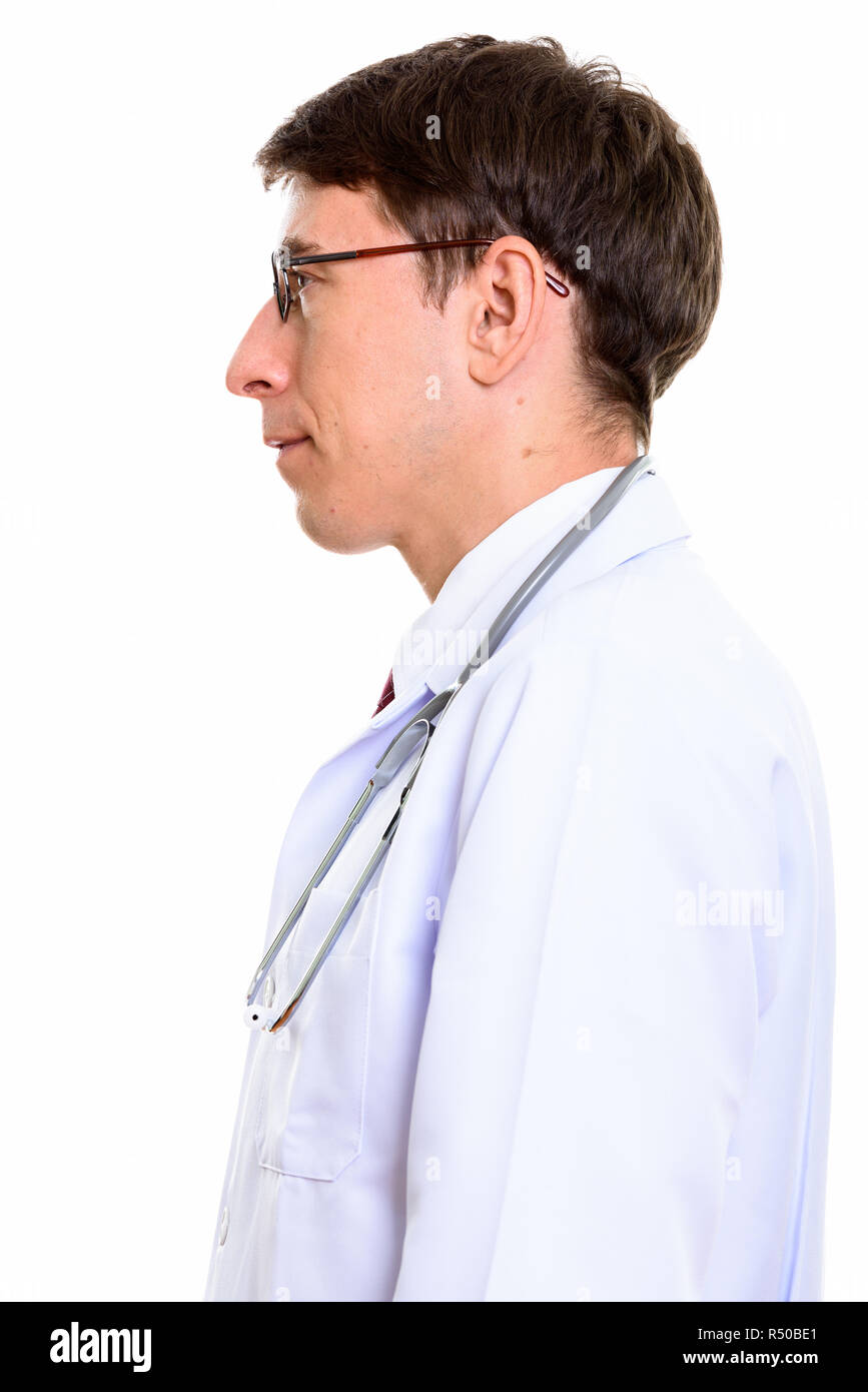 Profile view of man doctor standing against white background Stock Photo