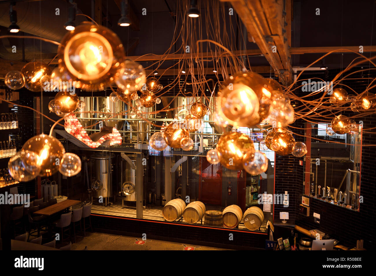 Amsterdam Brewhouse brewery tanks and beer barrels through lights above