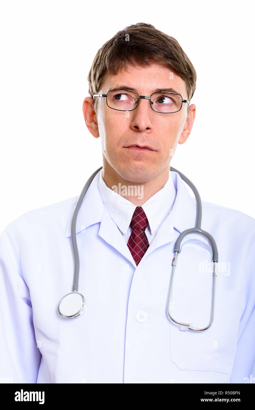Close up of man doctor thinking while looking up  Stock Photo