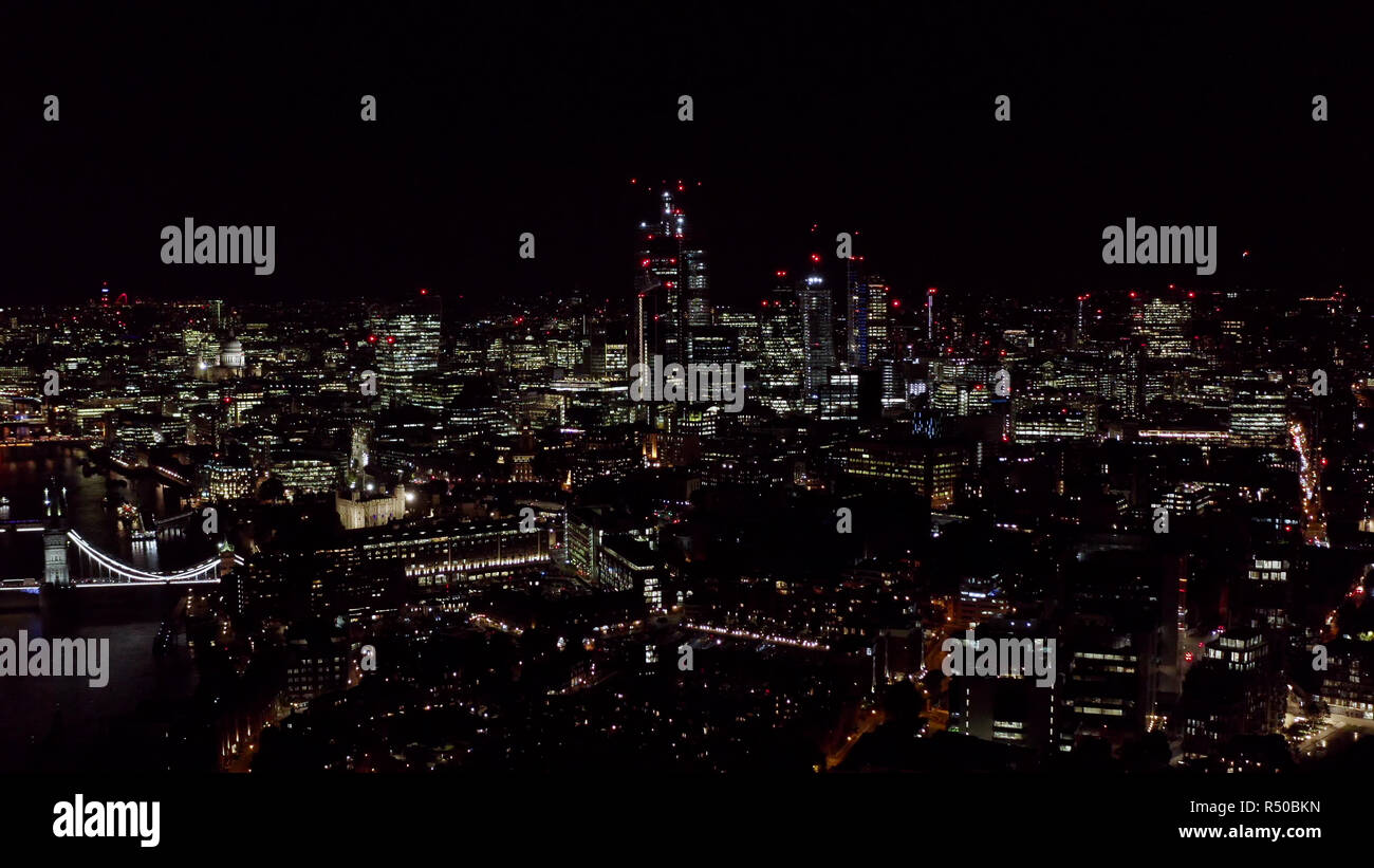 Aerial View London City View feat. New Modern Office and Business Buildings Lights in the Financial District at Night in England, United Kingdom Stock Photo