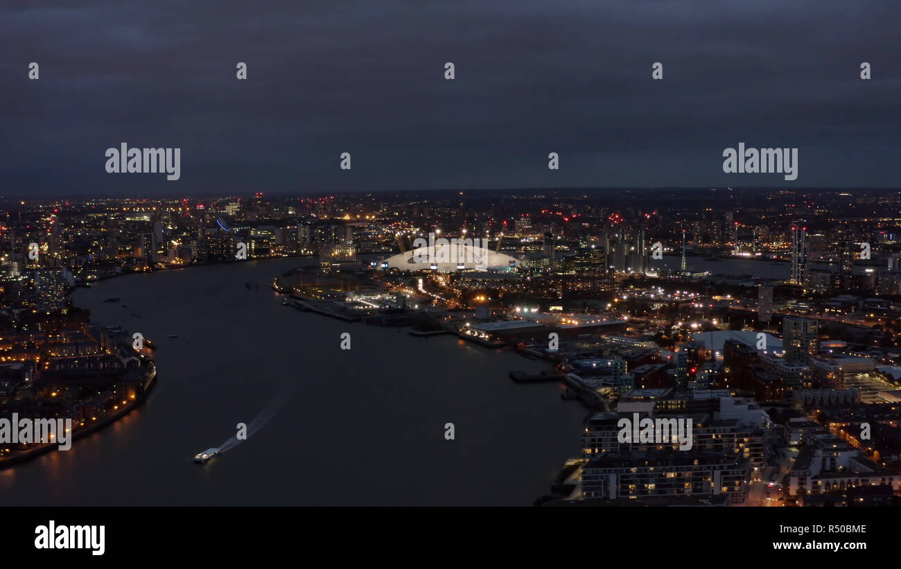 Beautiful London Riverside Skyline and Cityscape Aerial Night View feat. River Thames, The O2 Arena - Millennium Dome is large entertainment district  Stock Photo