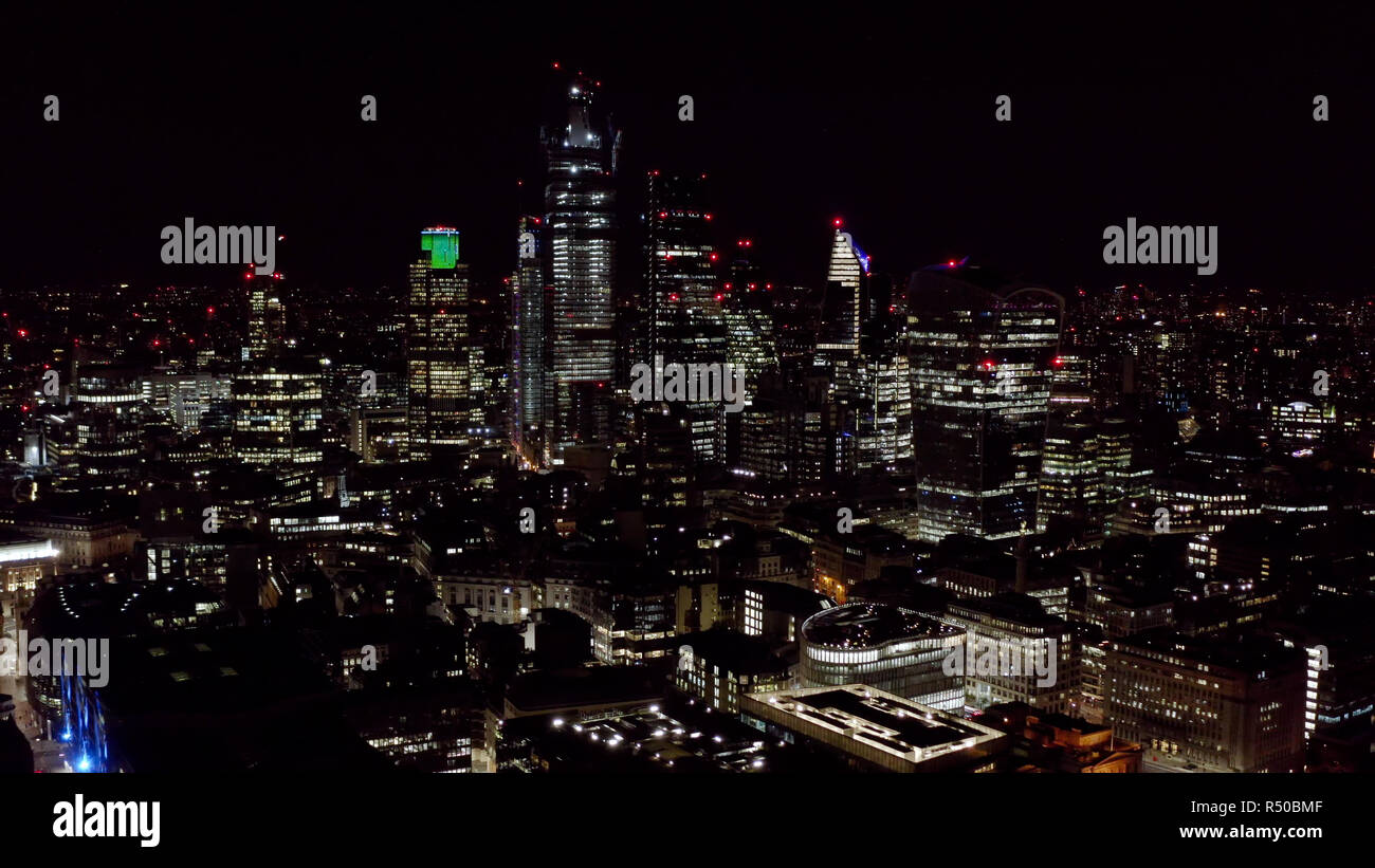 Aerial View of Urban City at Night. Modern High Rise Buildings and Office Towers in Business and Financial District. High Up Shot of London City UK Stock Photo