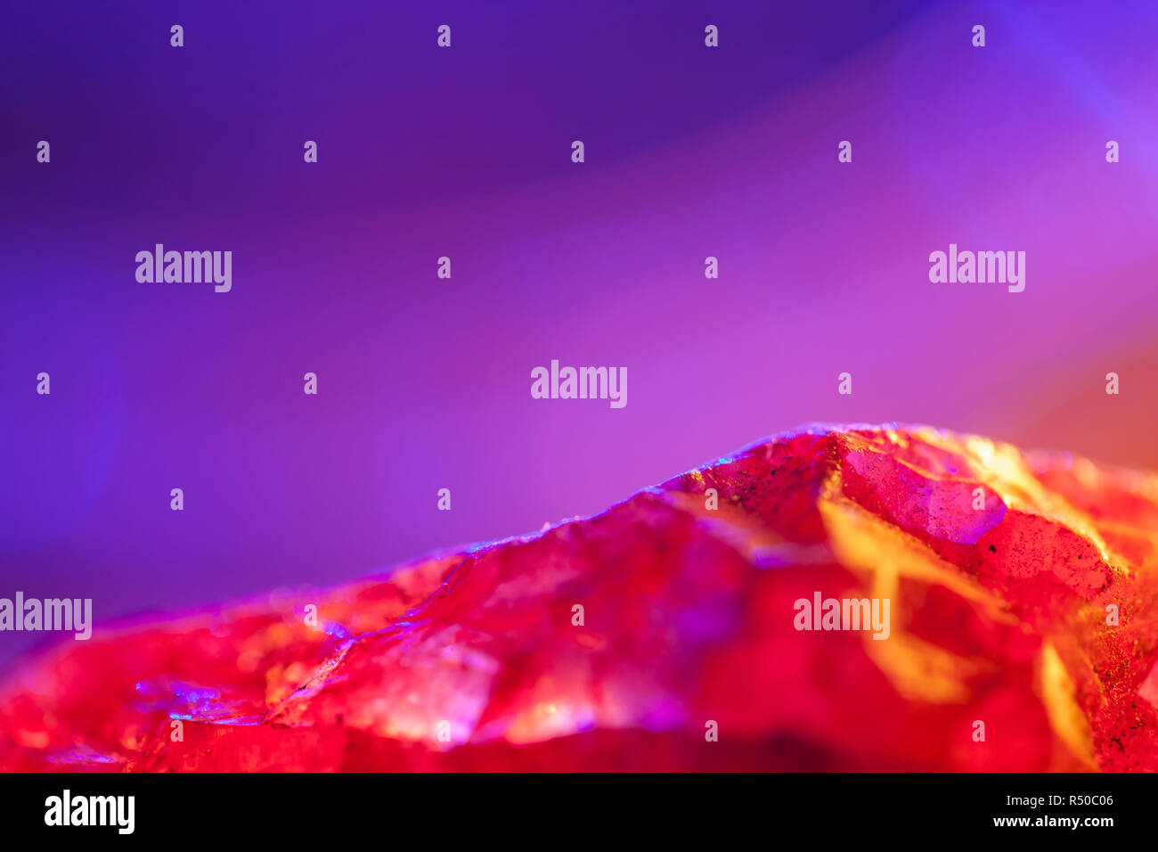 Pink Quartz crystal specimen shot using beautiful colourful lighting.Pink Gemstone.With copy space. Stock Photo