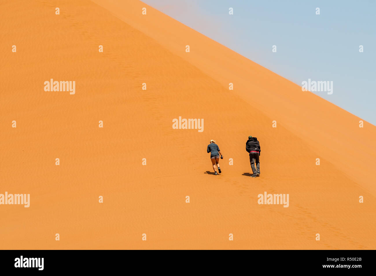 two persons climning Dune 45 ,namib desert, Namibia Stock Photo