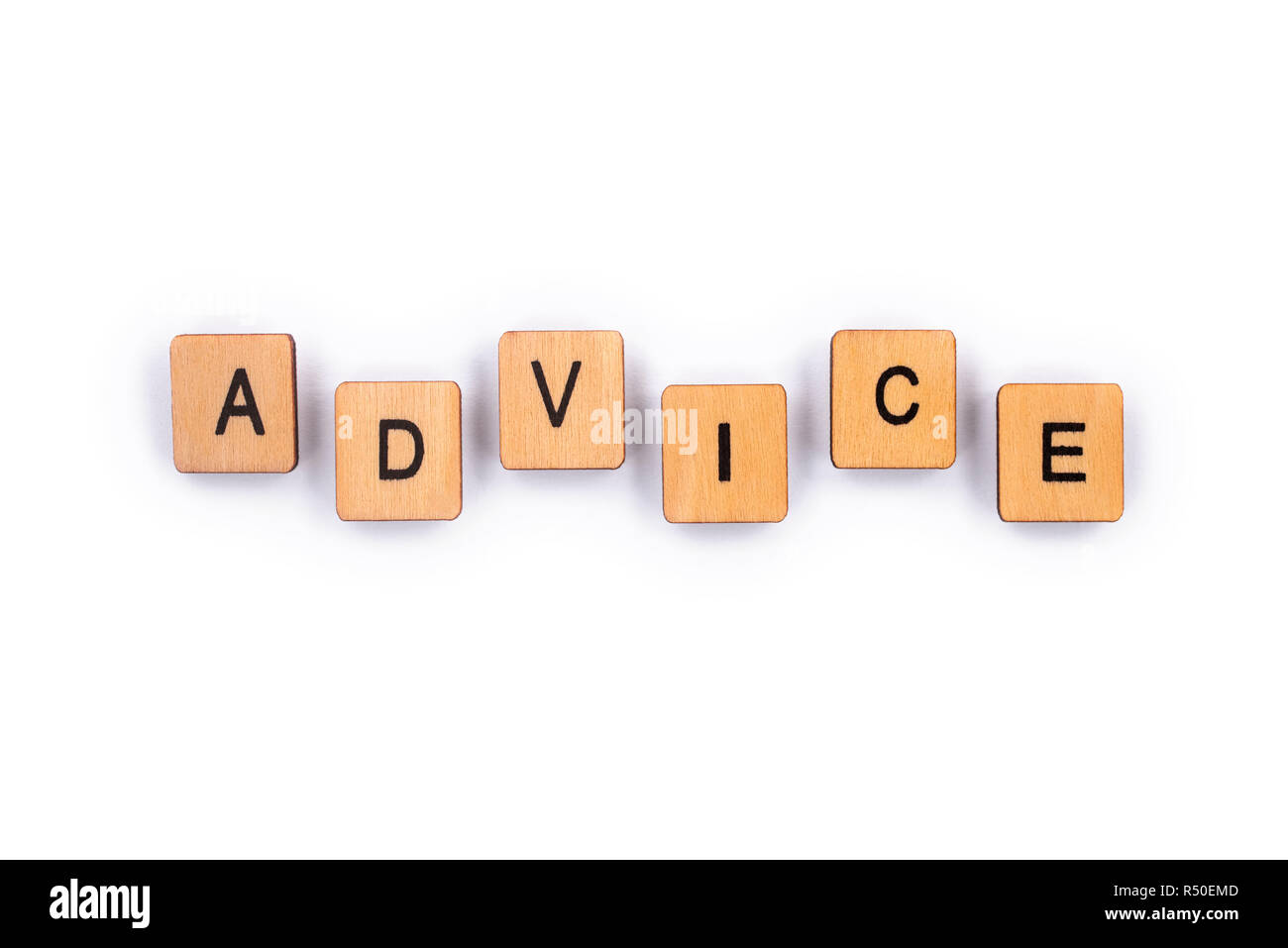 ADVICE, spelt with wooden letter tiles over a plain white background. Stock Photo
