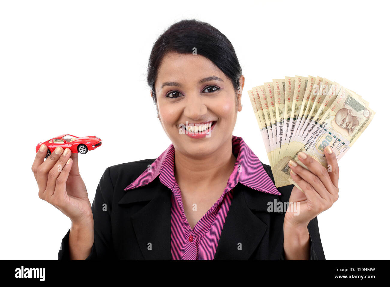 Cheerful business woman with money and toy car Stock Photo