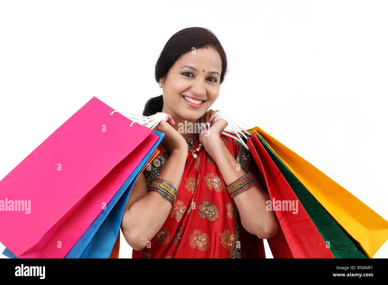 Cheerful traditional Indian woman with shopping bags Stock Photo