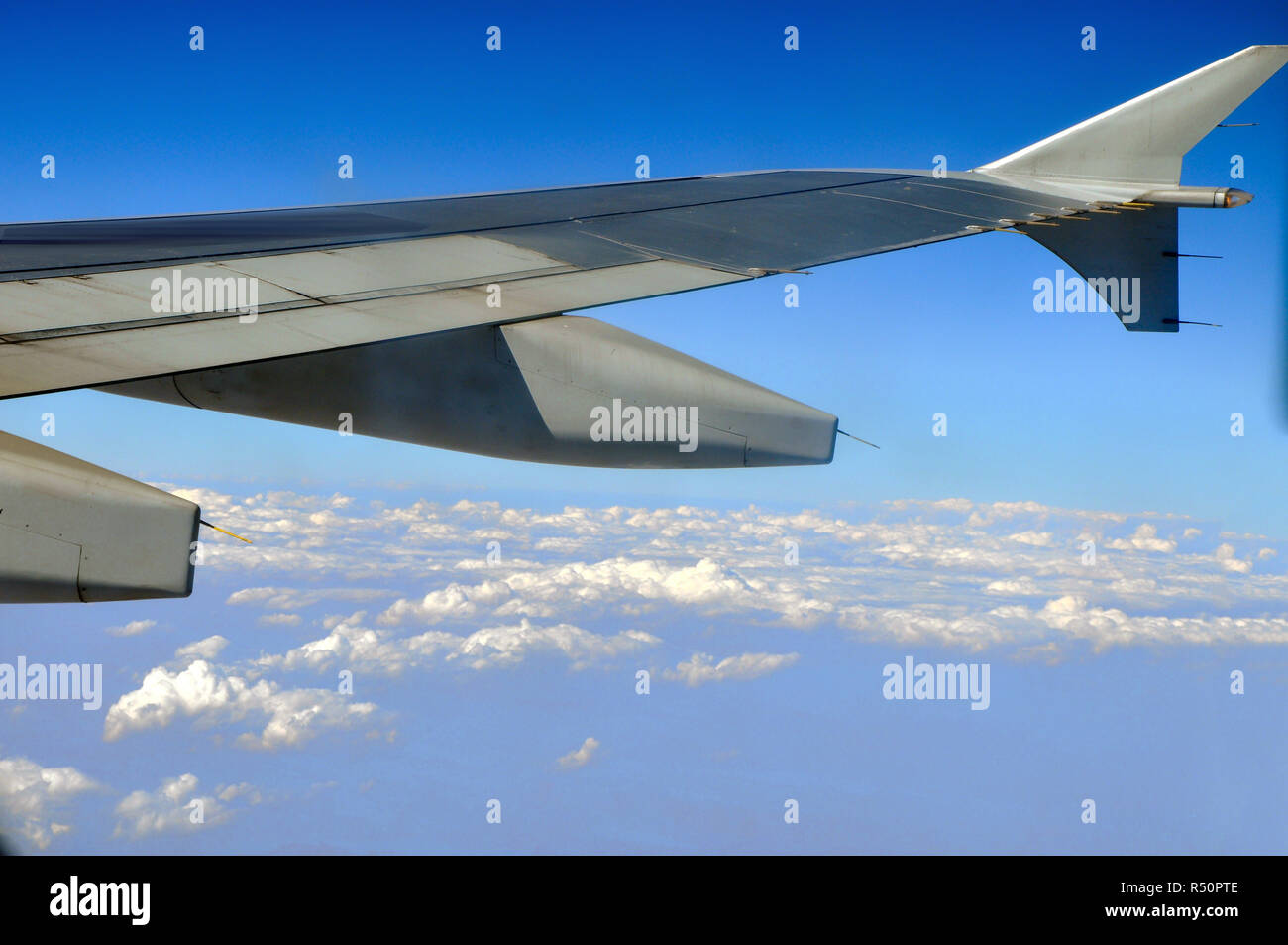 Clouds under the airplane's wing Stock Photo