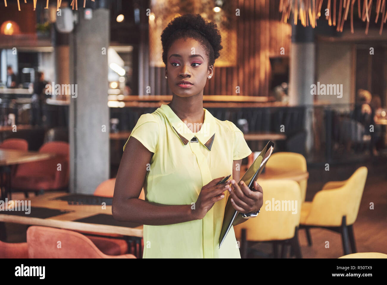 African American business woman stands with a folder in her hands Stock ...
