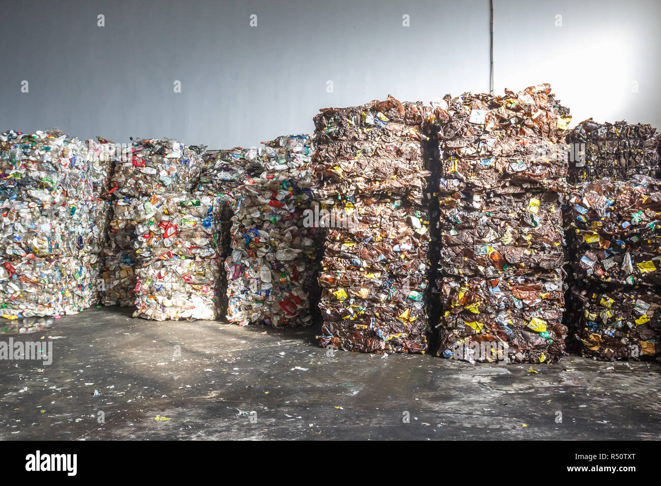 Plastic bales of rubbish at the waste treatment processing plant. Recycling separatee and storage of garbage for further disposal, trash sorting. Busi Stock Photo