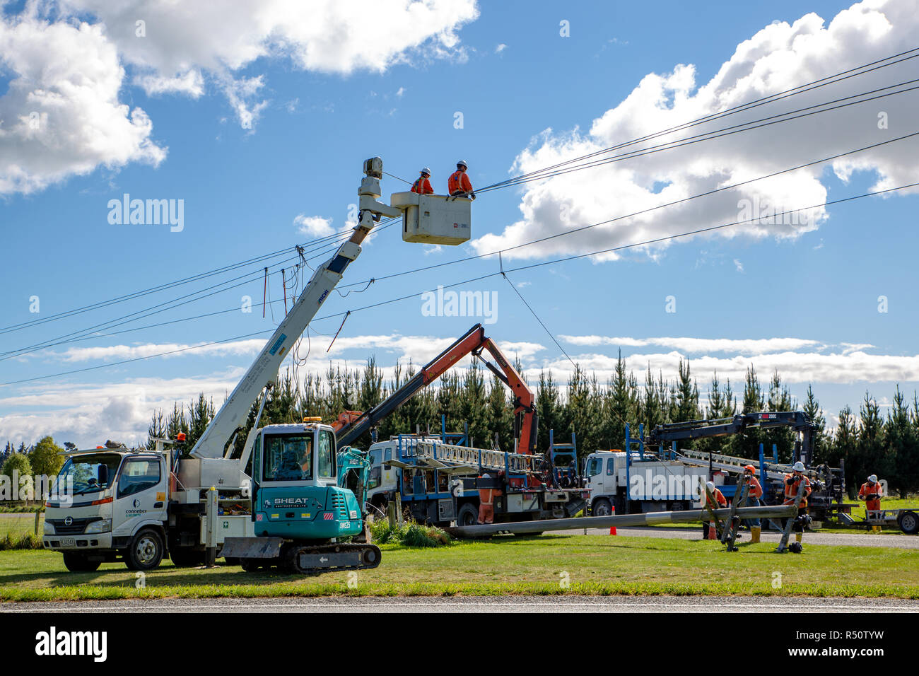 Coalgate, Canterbury, New Zealand - September 27 2018: Power linesmen work on putting up new poles and repairing and improving the power supply Stock Photo