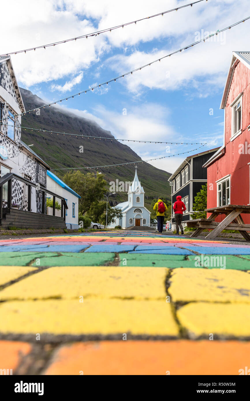 The main walking street of Seydisfjordur is painted in bright colors of the rainbow, Iceland Stock Photo