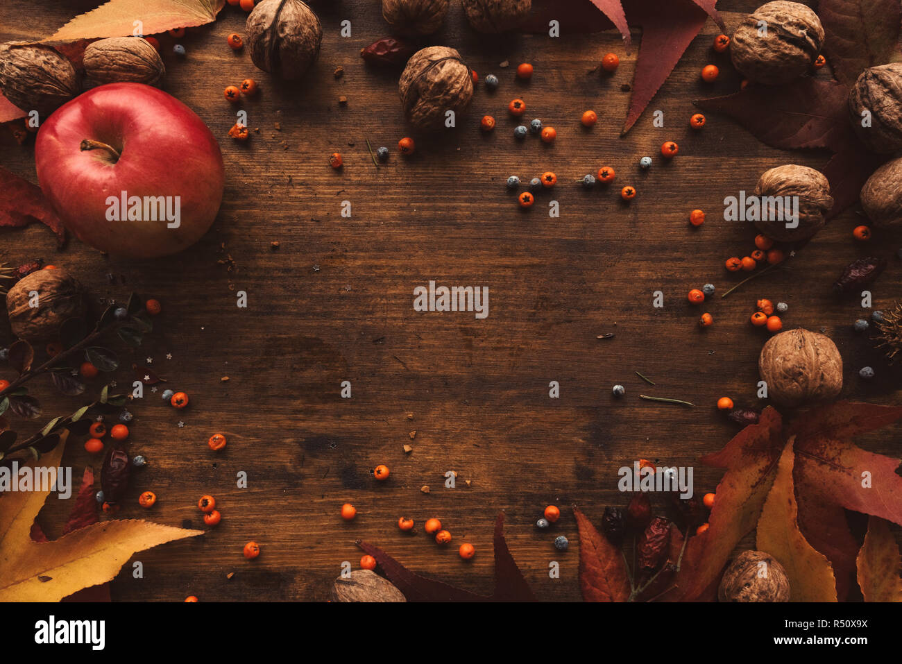Autumn fruit, berries and leaves on wooden background. Flat lay top view with copy space. Stock Photo