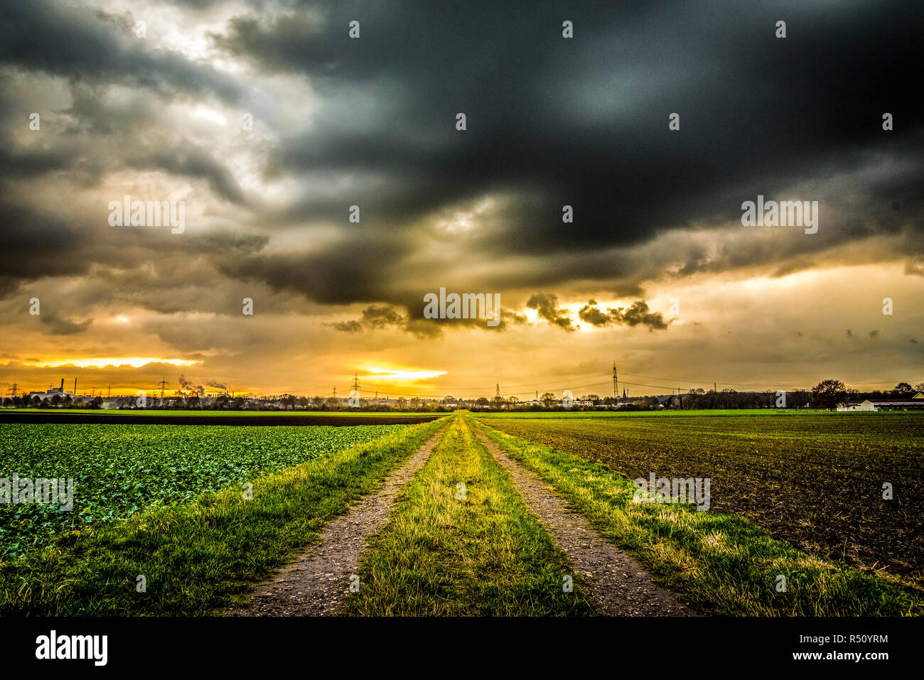 dirt road in front of a dramatic sky Stock Photo