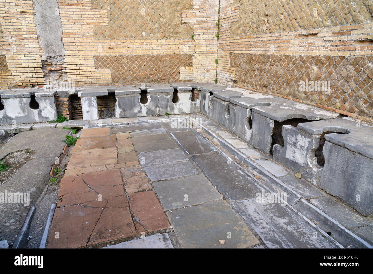 Ostia antica in Rome, Italy. Roman public latrine found in the excavations of Ostia Antica Stock Photo