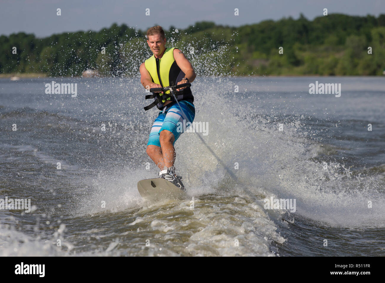 Front view photograph of man wakeboardingÂ on river Stock Photo