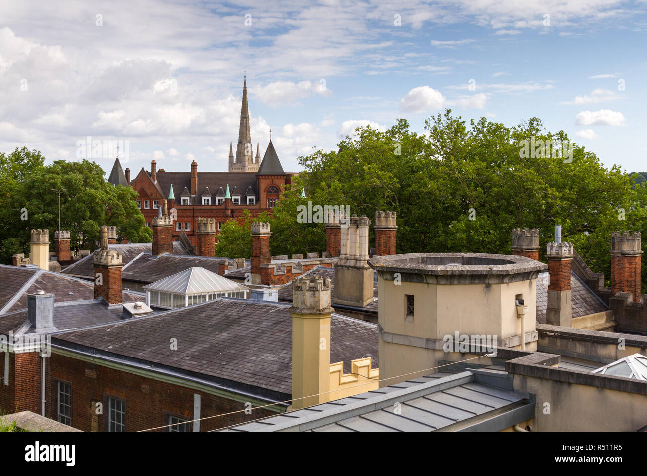 Norwich Cathedral spire above city rooftops Stock Photo