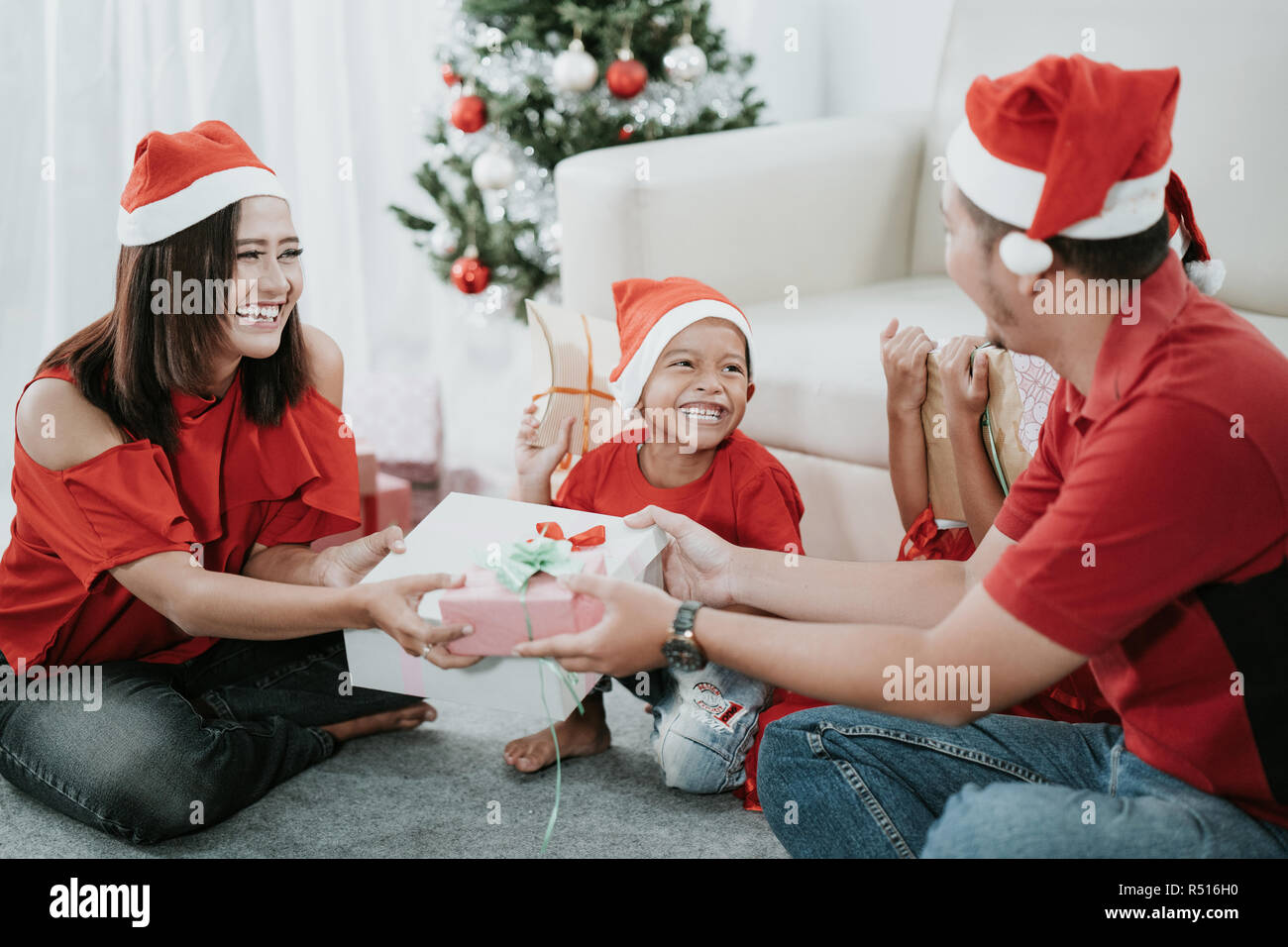 christmas gift exchanged tradition of asian family with two kids Stock Photo Alamy