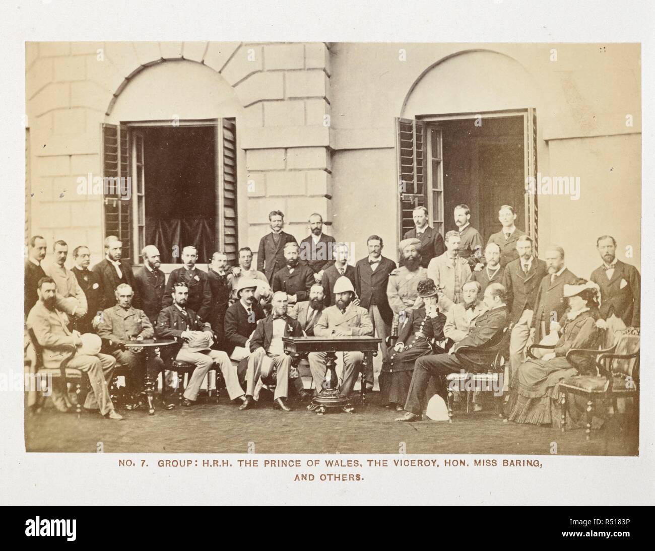 Group: H.R.H. The Prince of Wales, the Viceroy, Hon. Miss Baring and others [at Government House, Calcutta]. Group portrait: 'The Prince will at once be recognised in this capital photograph. His Royal Highness, the only person in the group not uncovered, has Lord Northbrook on his right and Miss Baring on his left. Prince Louis of Battenberg is sitting next to Lord Northbrook, Lord Suffield just behind, and Sir Henry Norman behind him. The Prince's suite are chiefly to the left of the picture, the Indian officials to the right' . Bourne & Shepherd, 'Royal photographic album of scenes and pers Stock Photo
