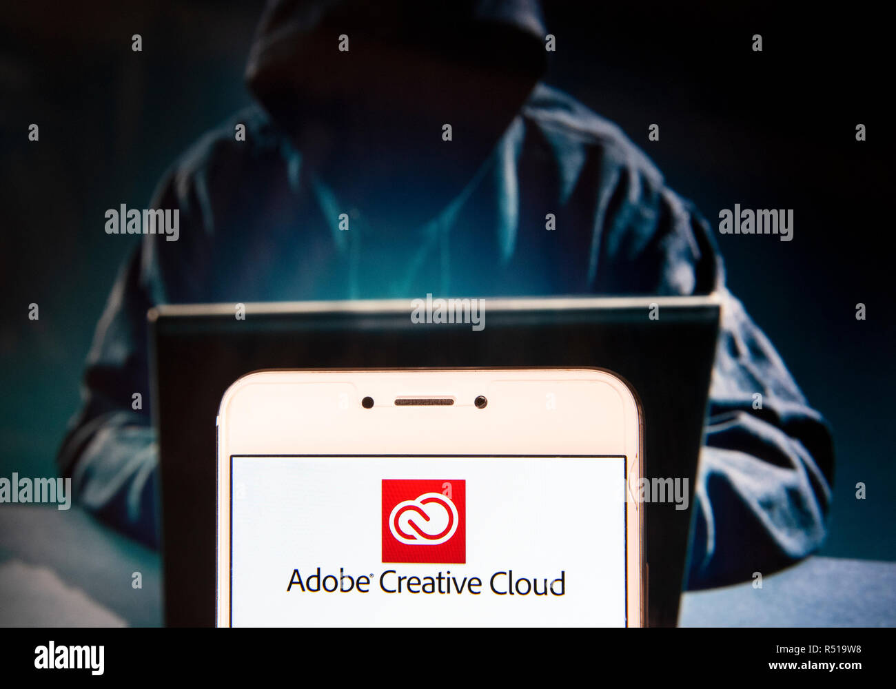 File hosting service and computer software access owned by Adobe Systems, Adobe  Creative Cloud, logo is seen on an Android mobile device with a figure of  hacker in the background Stock Photo -