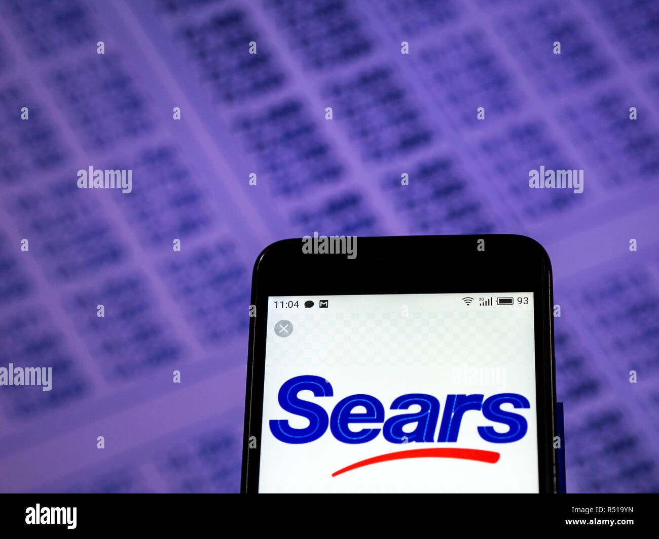 Sears Department store company logo seen displayed on smart phone Stock