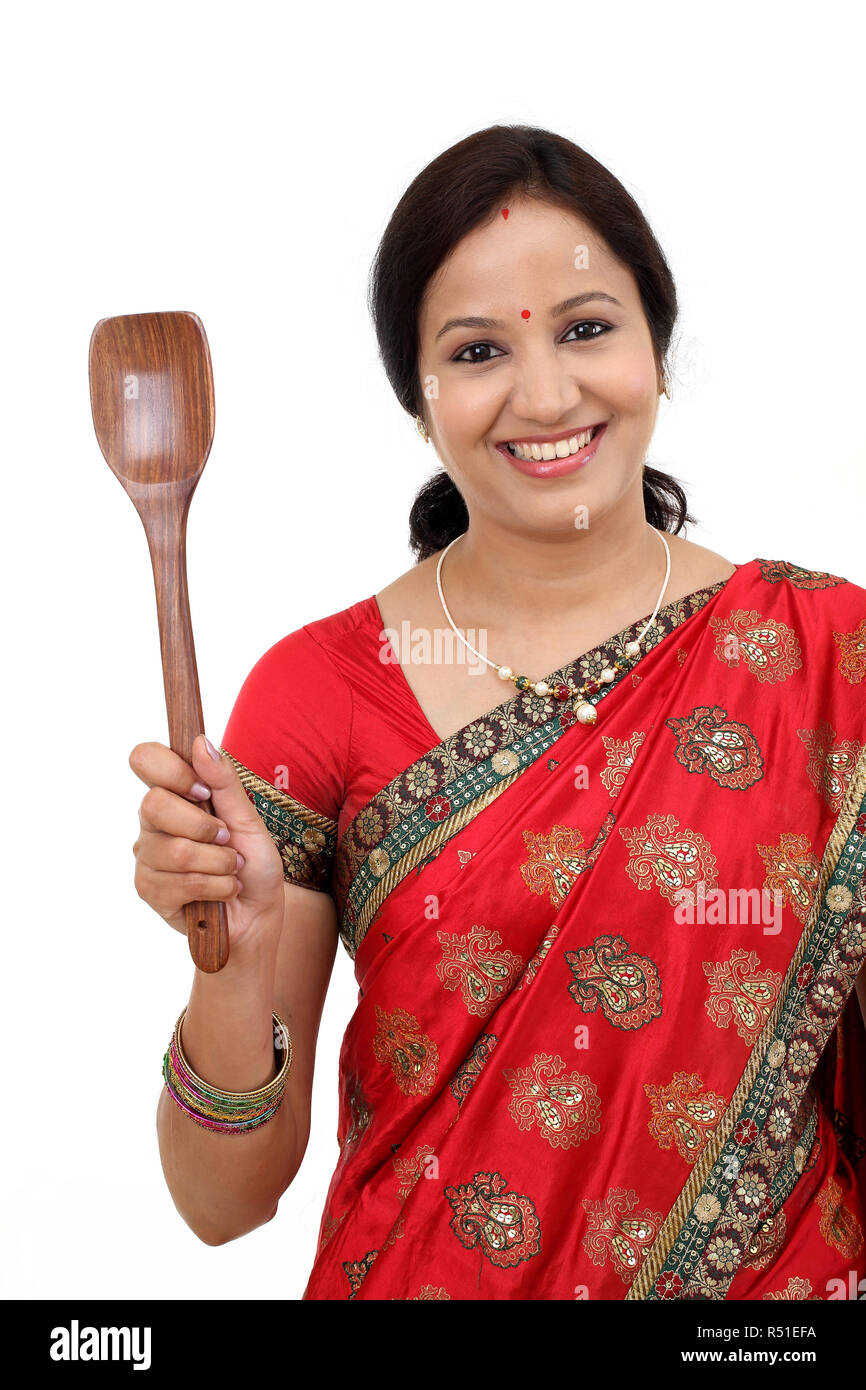 Traditional Indian woman holding wooden ladle Stock Photo Alamy