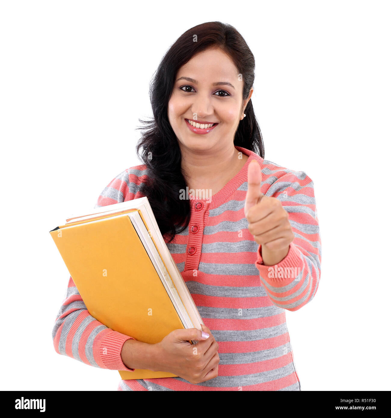 Young female student with thumbs up gesture Stock Photo - Alamy